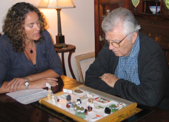 Woman with curly hair and man with gray hair using communication board