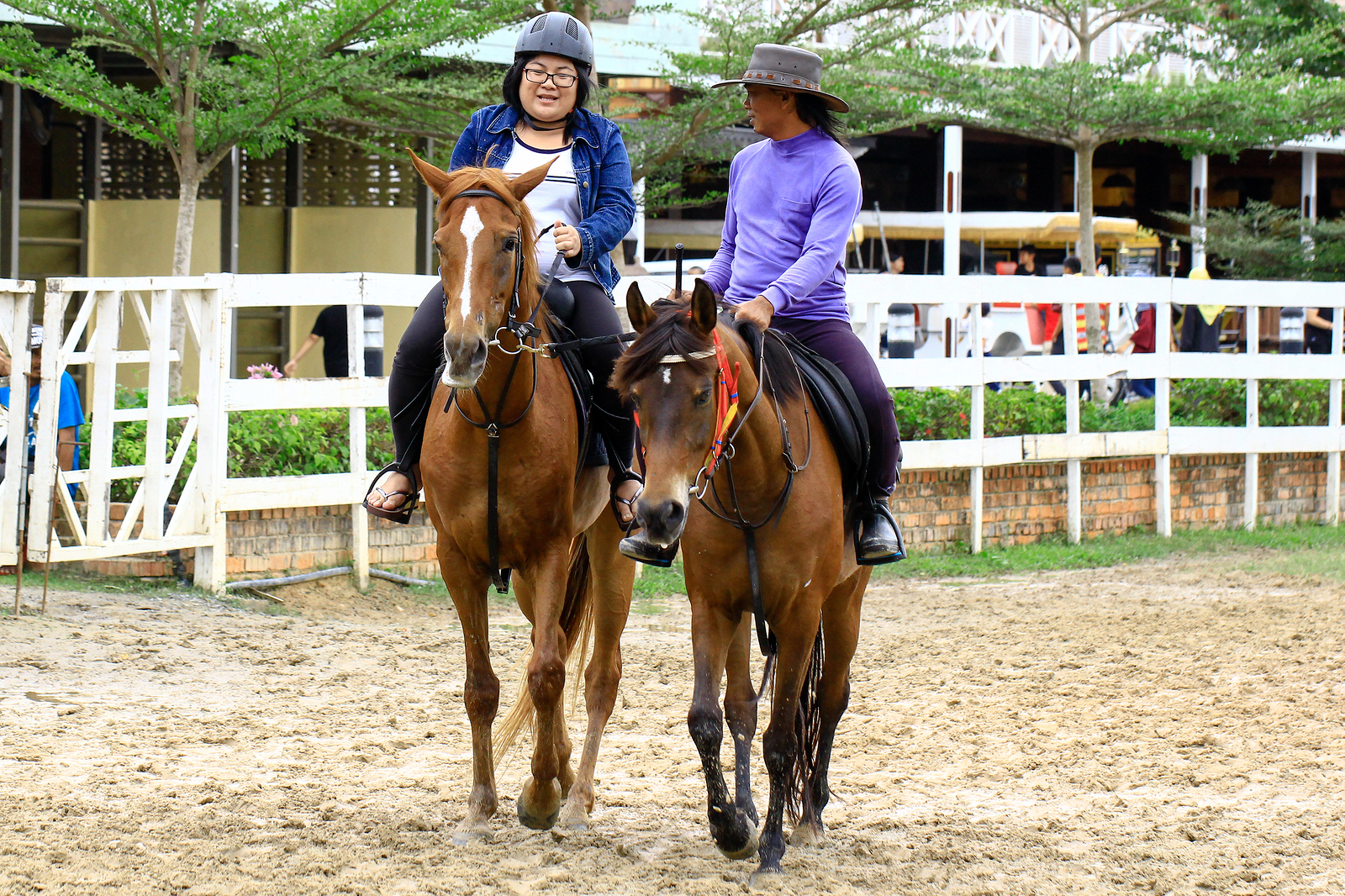 Girl and her instructor riding horses