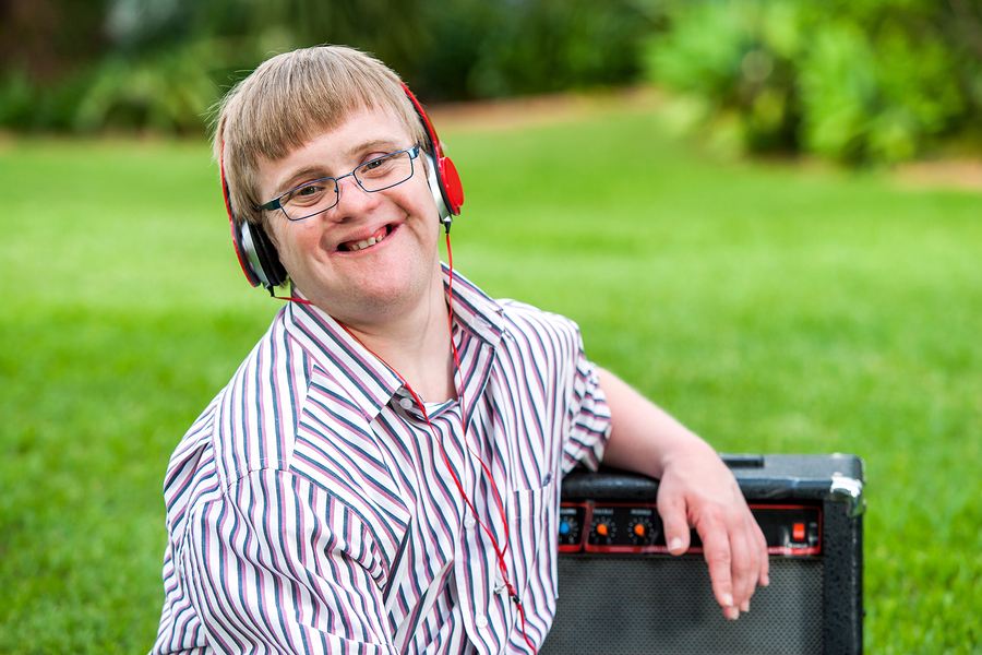 Youth with down syndrome wearing headphones