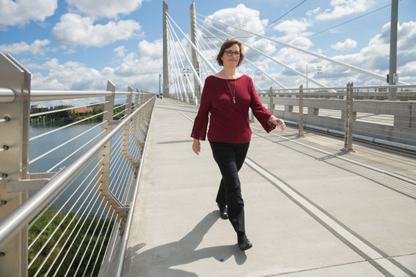 Alisa Brewster walking across the Tilikum Crossing Bridge