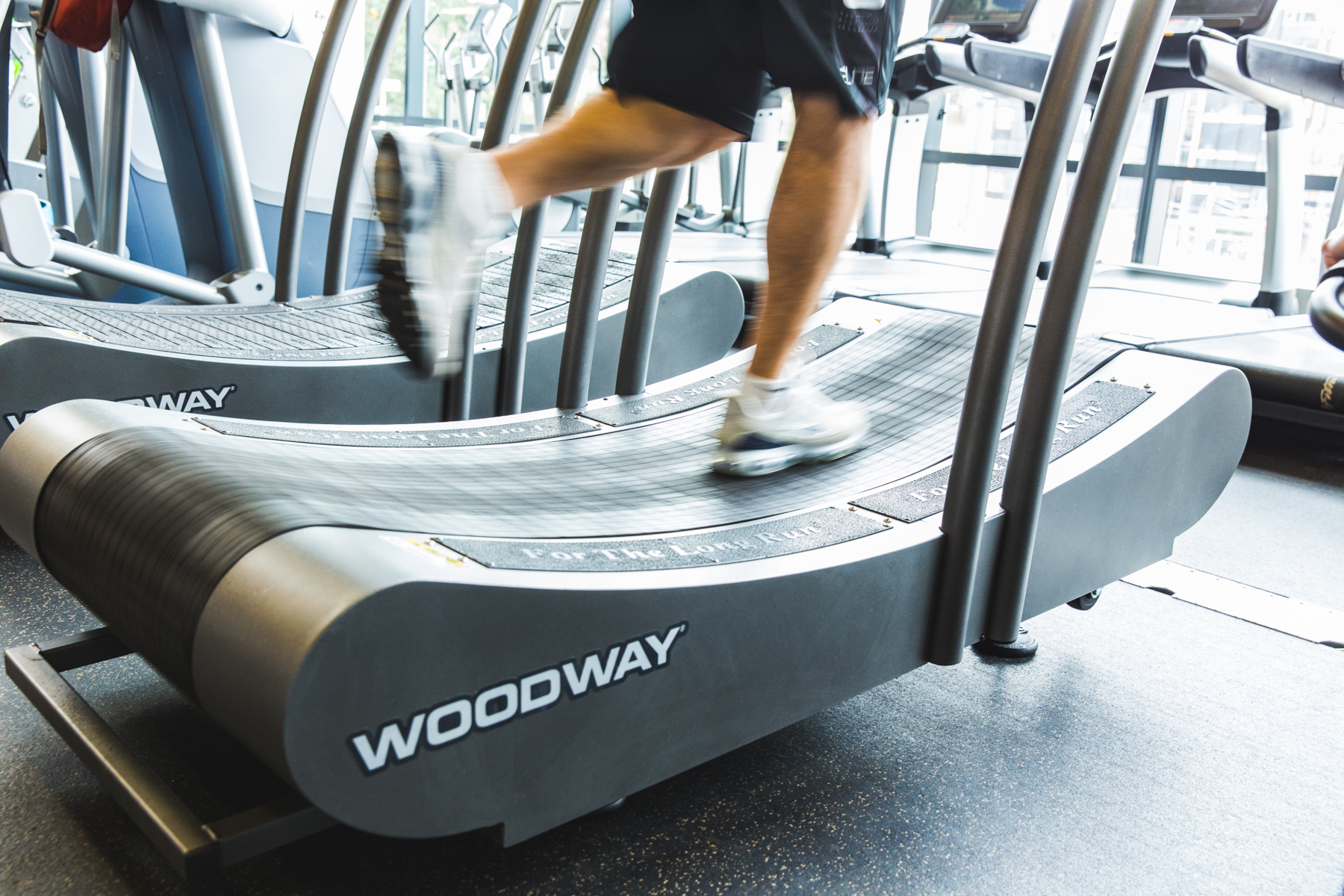Runner in motion on march wellness & fitness center's Woodway curved treadmill.
