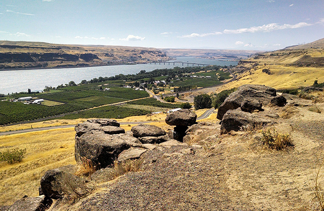 Eastern, agricultural area along the Columbia River Gorge with big boulders in the foreground