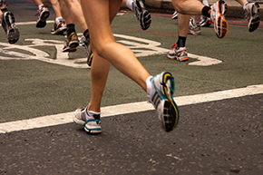 Photo of runners on pavement from the knee down.