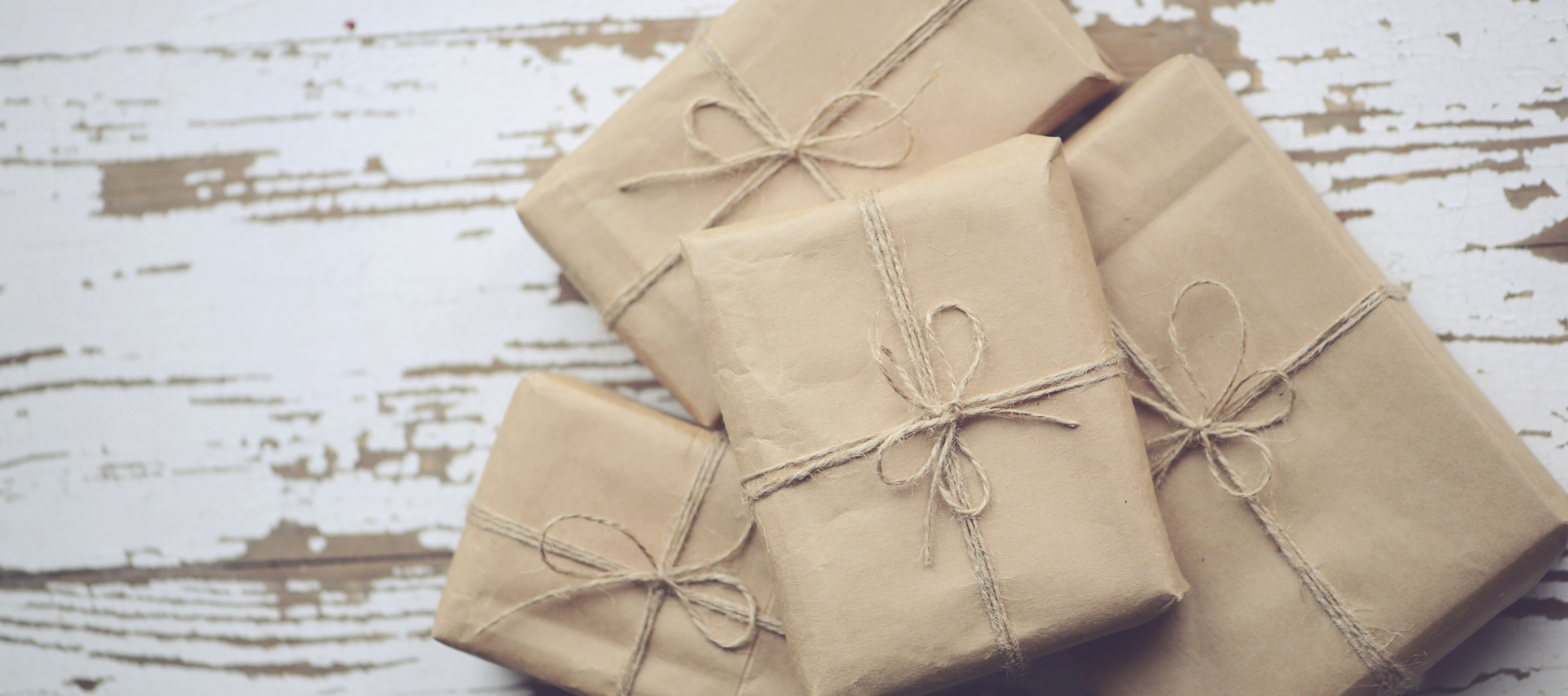 Packages wrapped in brown paper with jute bows