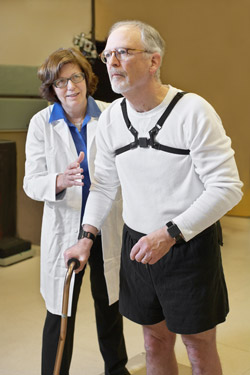 Dr. Horak attends a person who is wearing sensors.