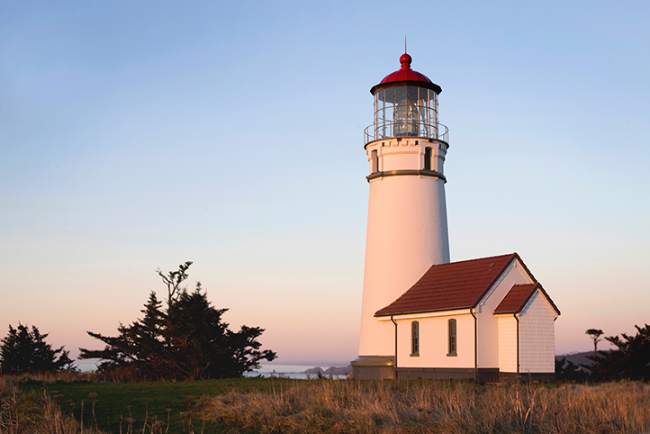 White lighthouse on the South Coast of Oregon at sunset