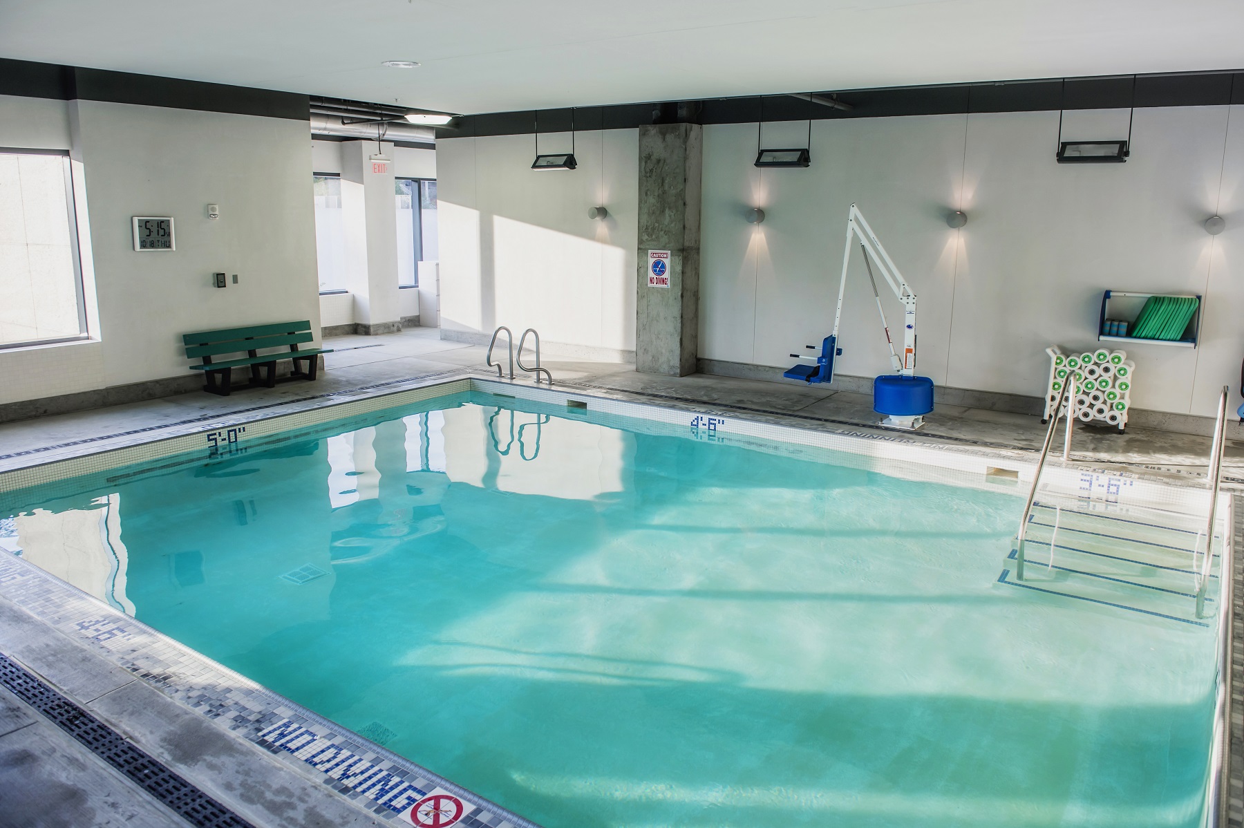 Wide view of warm water therapy pool including pool lift.
