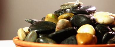 A bowl containing a pile of smooth river stones
