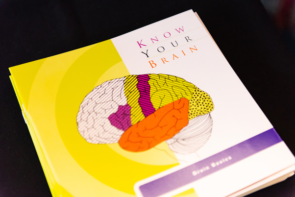 A pamphlet from NIH called "Know Your Brain" displayed on a table.