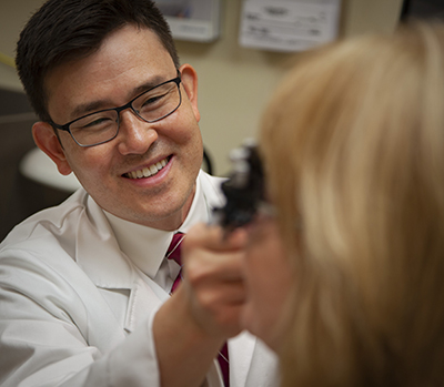Dr. Labrum examines a patient in the Vision Rehabilitation Center.