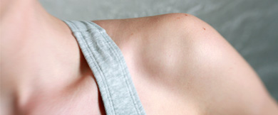 A closeup of the shoulder of a person wearing a tank top.