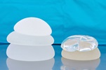 An image showing silicone and saline breast implants in different sizes