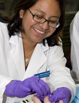 A smiling researcher performs a health screening