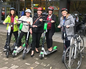 Moore Institute employees on electric scooters