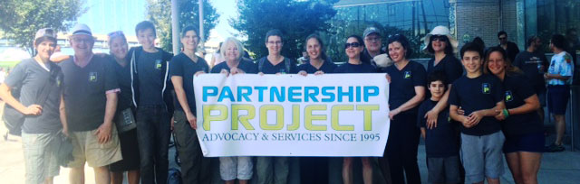 Partnership Project team group photo at AIDS Walk Portland, with Partnership Project banner