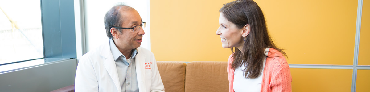 OHSU provider, Dr. Charles Lopez, speaks with a patient in the Hematology Oncology patient waiting room