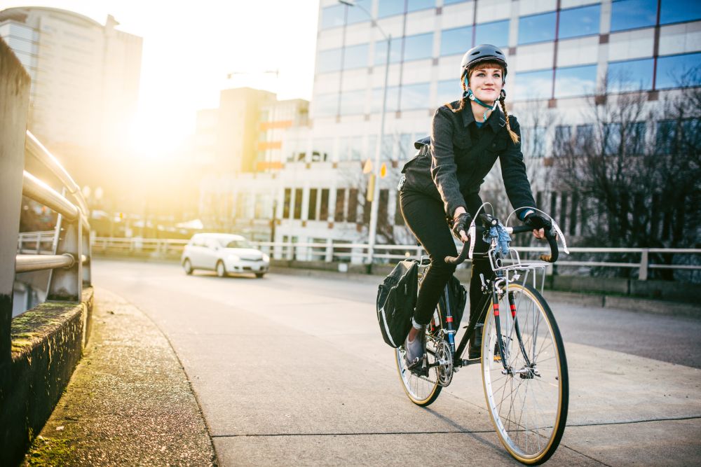 Woman commuting on a bicycle in an urban area.