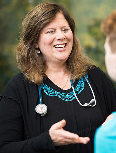 Dr. Natasha Polencek speaks with a primary care patient