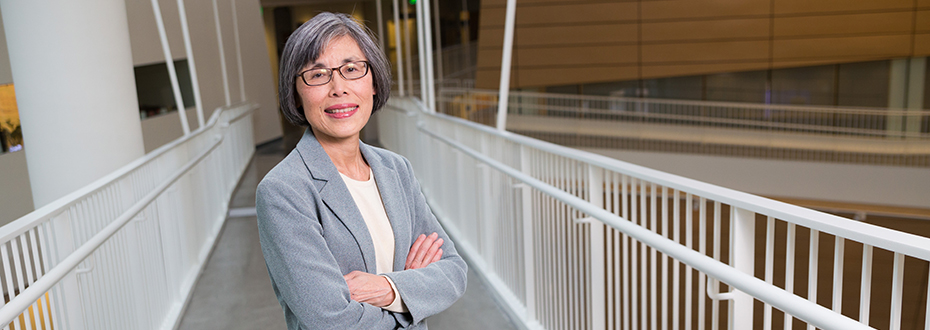 Dr. Maisie Shindo standing arms crossed in OHSU's Robertson Life Sciences Building.