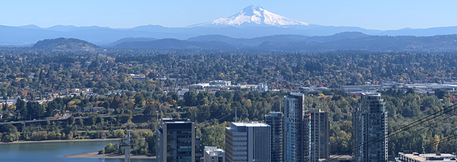 A scenic photo taken from OHSU looking out at Portland's South Waterfront and Mt. Hood in the background.