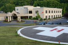 photo of a hospital entrance with outdoor ground level helipad