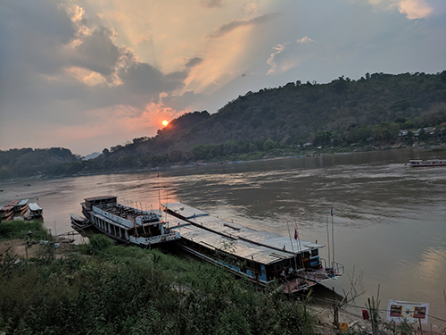 An image of a river at sunset in Laos.