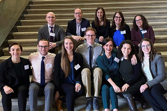 A group of OHSU Pediatric Residents sitting together on stairs at the Oregon State House.