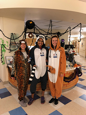 Three OHSU Pediatric Residents dressed in Halloween costumes in clinic.