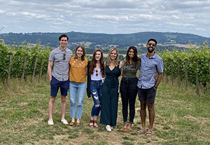 Four women and three men, all OHSU Pediatric Residents, pose while at a wine vinyard.