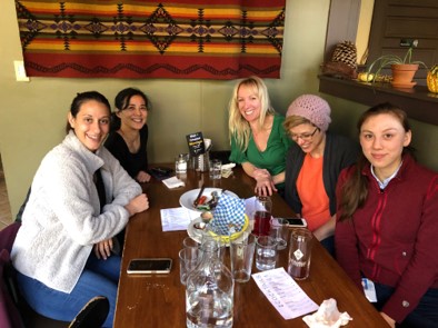 Napier Lab lunch 2019 at Saskquatch Brewing Co. sitting at an inside table with food and drinks, Ruth Napier, Sydney Lashley and Emily Vance from the Napier Lab at OHSU