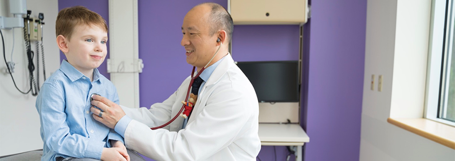 Pedatrician Dr. Derek Lam examines a young patient at Doernbecher Children's Hospital.