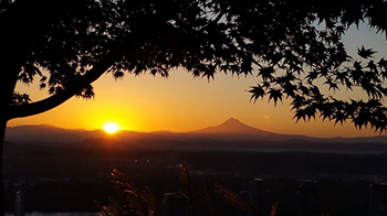 A photo from the top of Marquam Hill at sunrise with Mt. Hood in the distance.