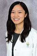 Doctor Milie Fang smiles in her white coat