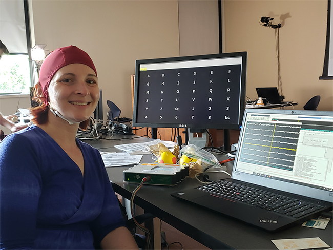 Woman wearing a brain computer interface cap.