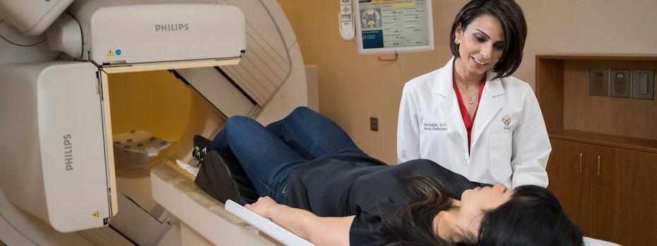 A doctor chats with a patient who is about to get a gamma scan.