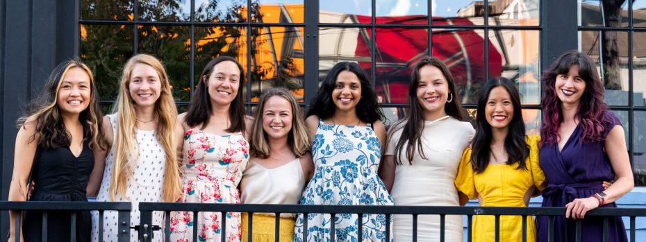 A group photo of the eight women comprising the 2026 OHSU OB/GYN Residency Class standing on a balcony.