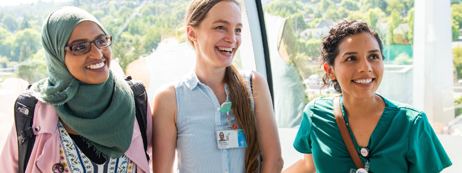 Three nursing students smile at something off-camera