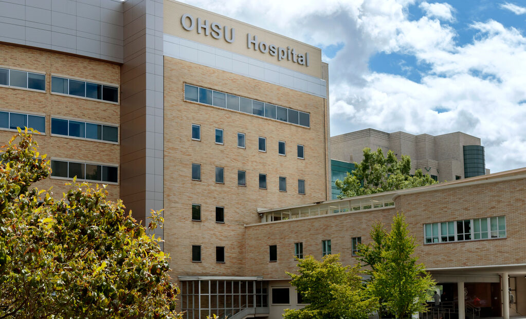Exterior view of the OHSU Hospital with trees on a sunny day