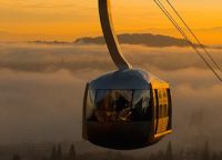 OHSU tram approaching the upper terminal on a foggy day at sunrise.