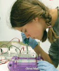 Women with her in a braid, leaning over medical tray.