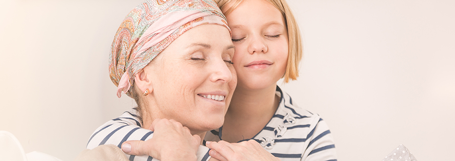 A young girl supports her mother as she recovers from having a bone marrow transplant