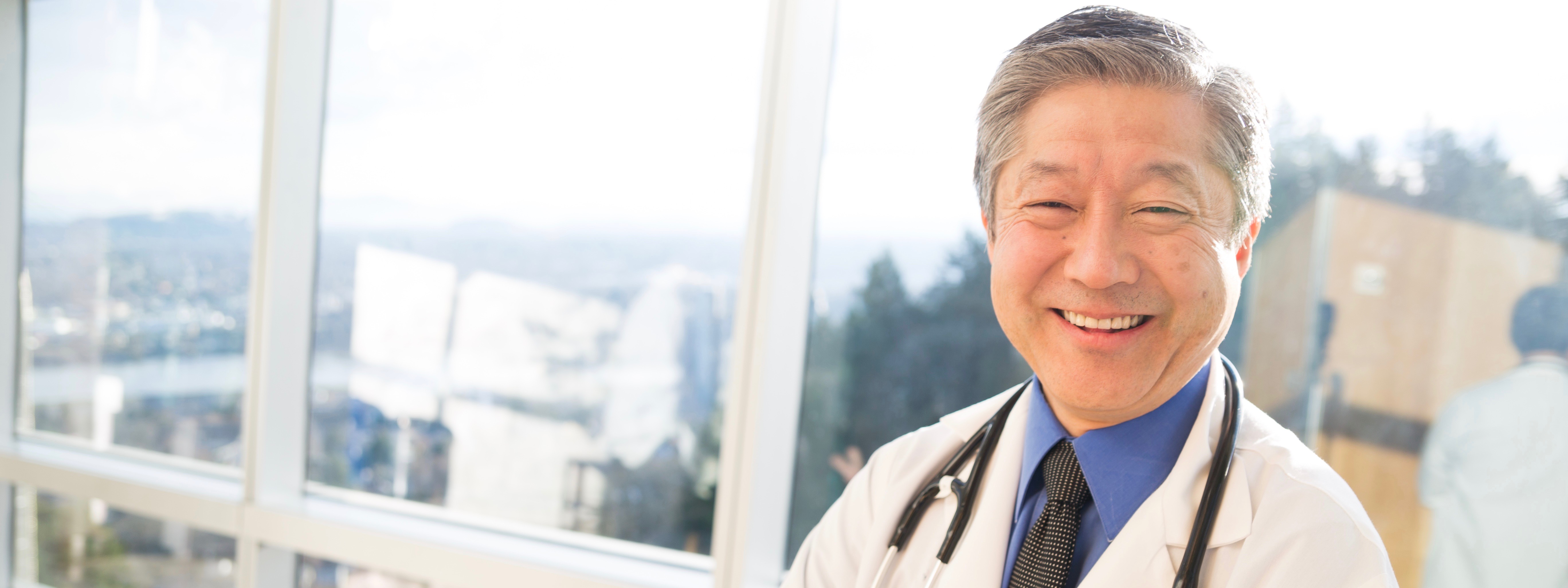 Dr. Craig Okada smiling.