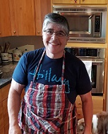 OHSU Spine Center patient Lupe smiles in the kitchen after her successful treatment at Oregon Health & Science University
