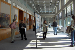 People looking at posters for DMICE open house