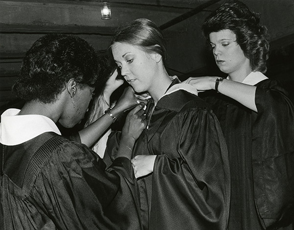 School of Dentistry  graduates Genevieve Chaney, Denise Johnson, and Alene de Stefanis prepare for commencement, 1980.