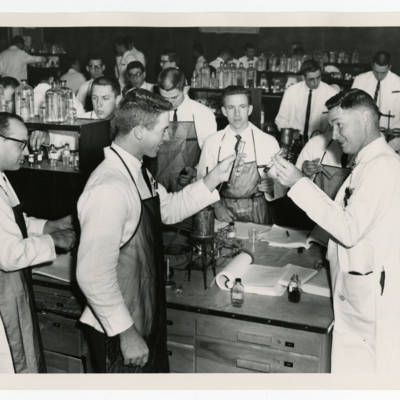 Cecil Keith Claycomb, M.S., Ph.D., working with students in a laboratory, 1963
