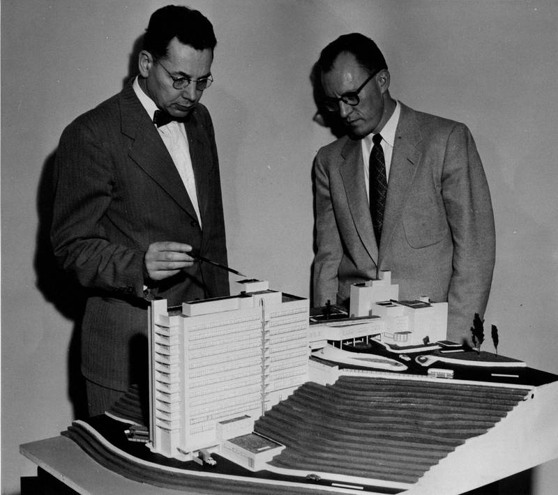 Dr. Charles Holman (left) and a colleague with the architectural model of the Medical School Hospital, erected in 1956