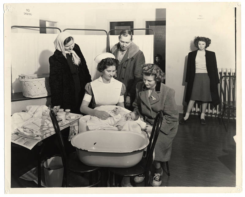 Student nurse bathing a baby, circa 1940s