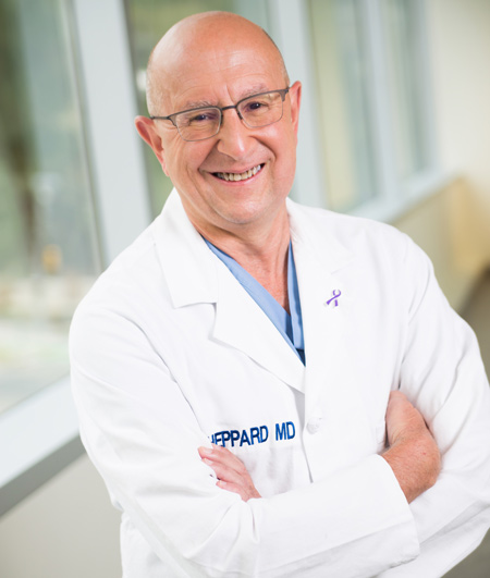 Dr. Brett Sheppard in white coat, smiling