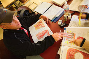 Student at desk with textbook open